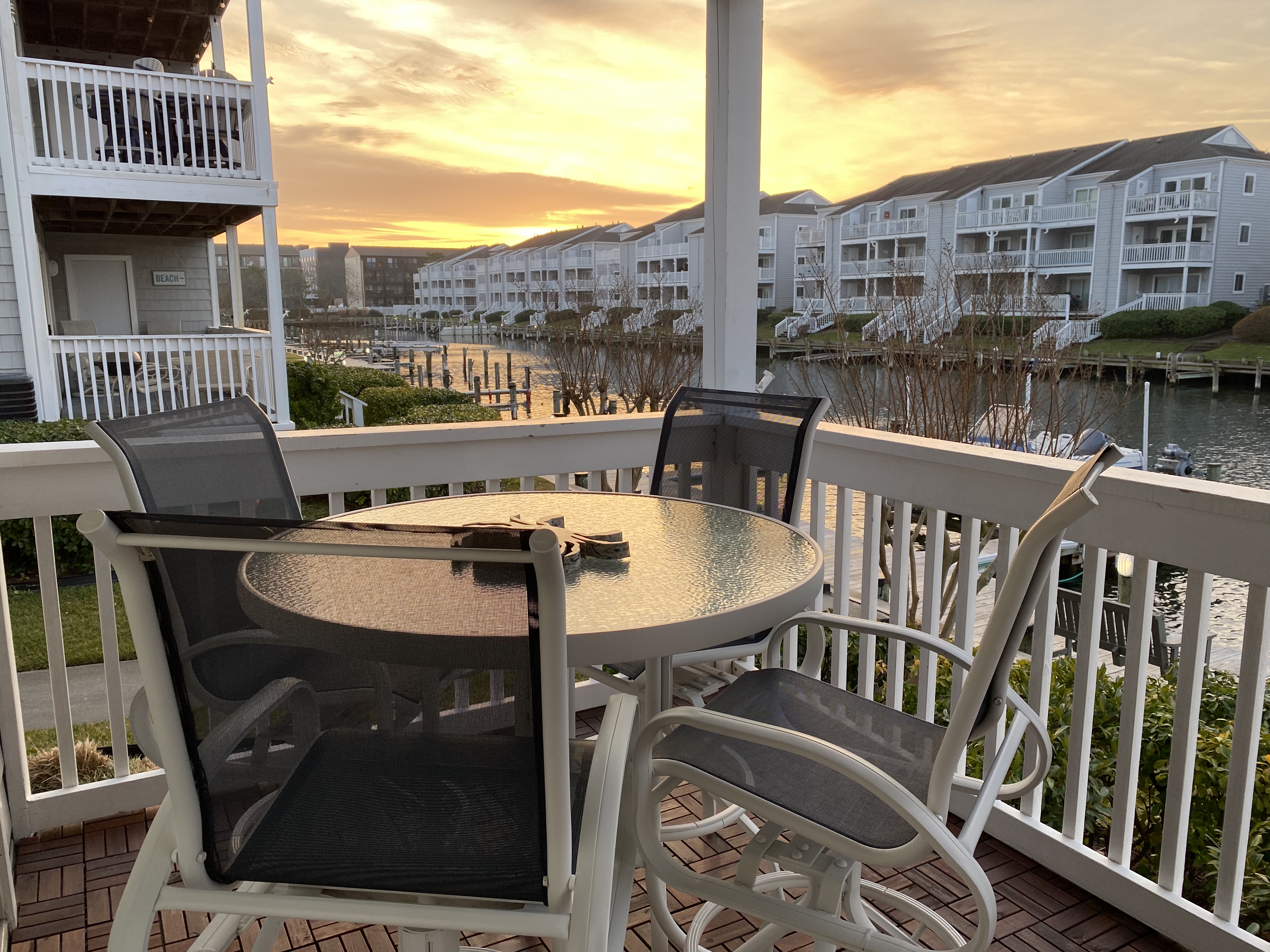 Canal Bungalow deck overlooking the marina at sunset — Ocean City, Maryland